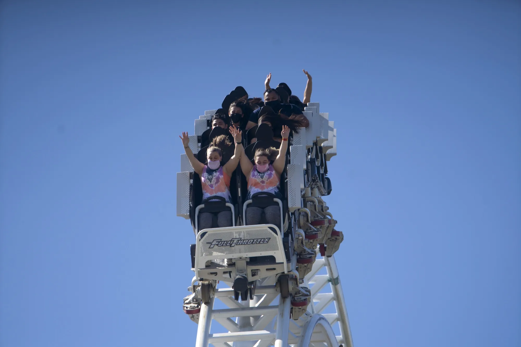 Visitors ride a roller coaster at the Six Flags Magic Mountain theme park in Valencia, California, on April 1.