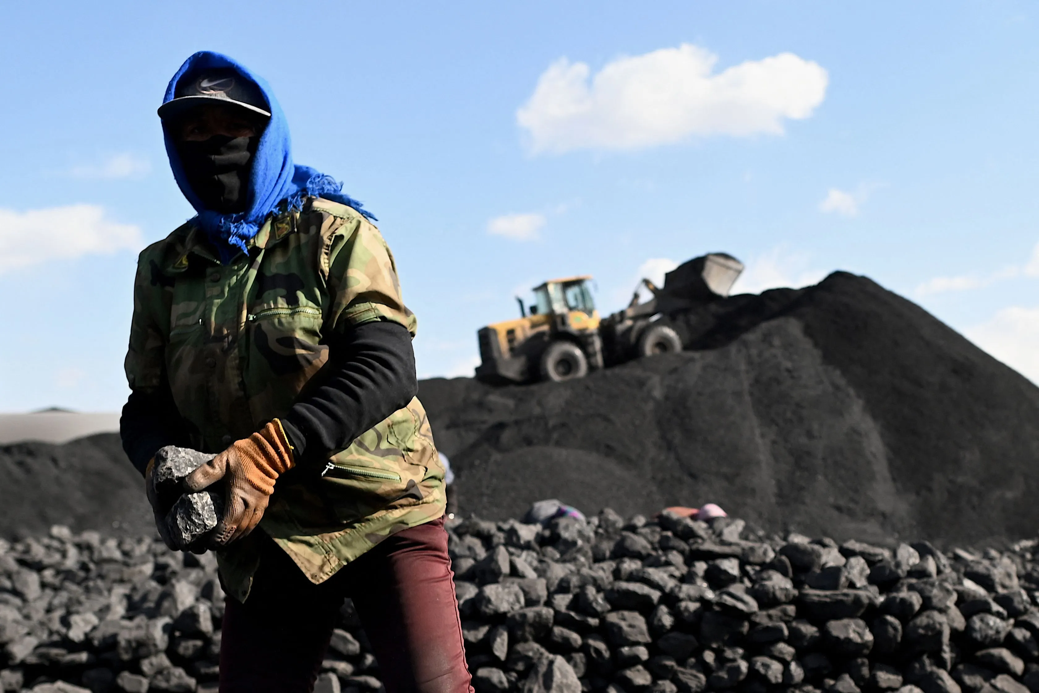 A worker sorts coal near a coal mine in Datong, Shanxi province.