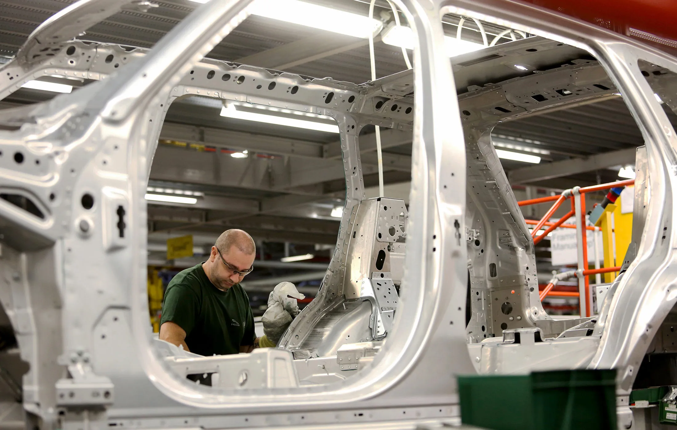 An employee works on the bodywork of a Range Rover Sport SUV at Tata Motors Ltd.'s Jaguar Land Rover vehicle manufacturing plant in Solihull, U.K.
