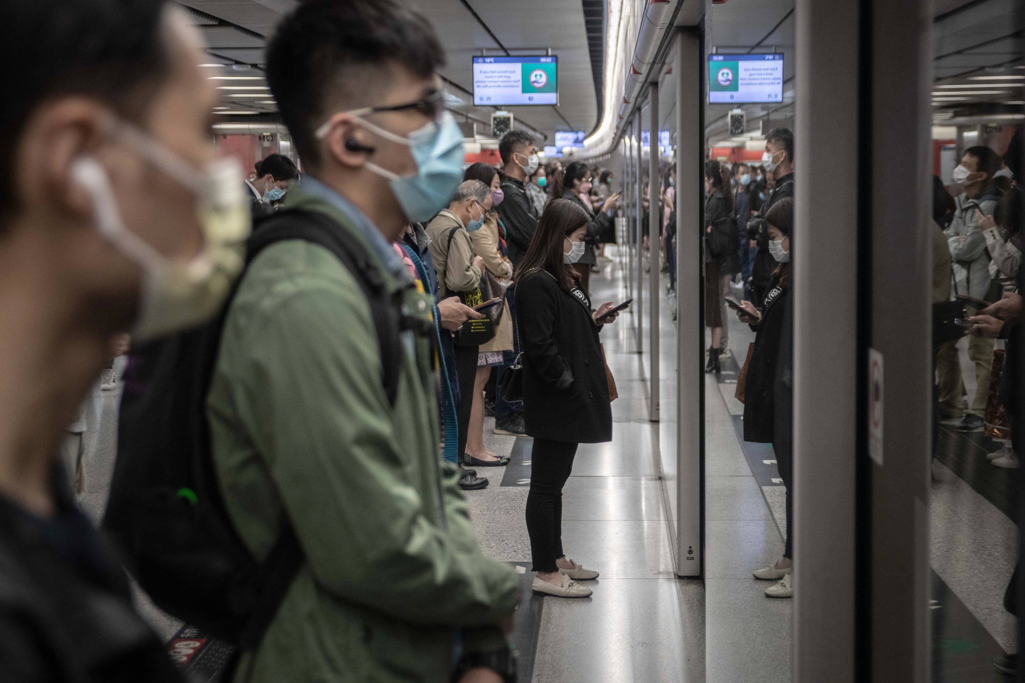 Passengers&nbsp;wait for a subway train&nbsp;in Hong Kong.