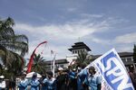 Protesters hold an action in front of Gedung Sate in Bandung, West Java, on August 28, 2025. The protesters are organized by labor alliances peacefully throughout Indonesia, demanding better labor laws and fair wages. (Photo by Ardi Septian/NurPhoto via Getty Images)