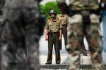 A North Korean soldier, center, looks towards the South Korean side of the truce village of Panmunjom in the Demilitarized Zone in Paju, South Korea.