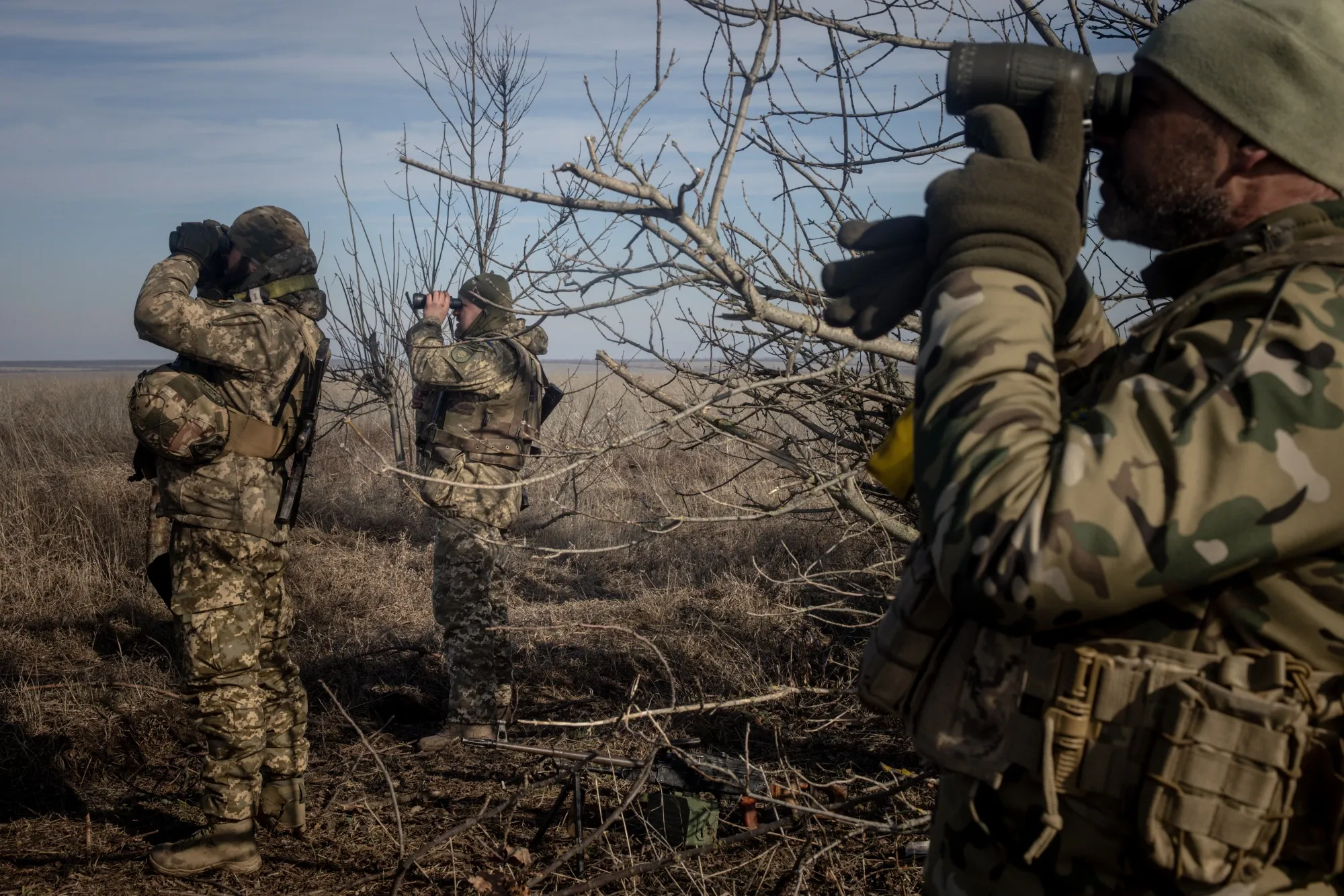 Members of Ukraine's 72nd Brigade Anti-air unit use binoculars to search for Russian drones near Marinka, Ukraine.