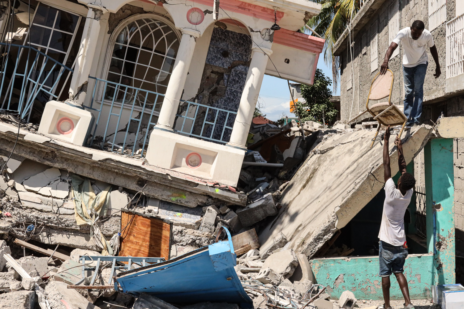 Residents survey a damaged building following a 7.2-magnitude earthquake in Les Cayes, Haiti, on&nbsp;Aug. 15.