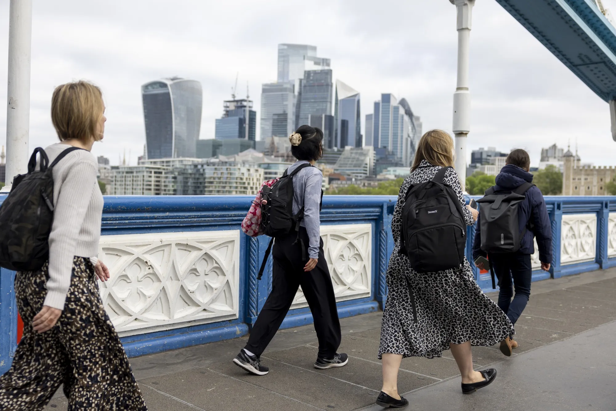 Commuters cross Tower Bridge in London.