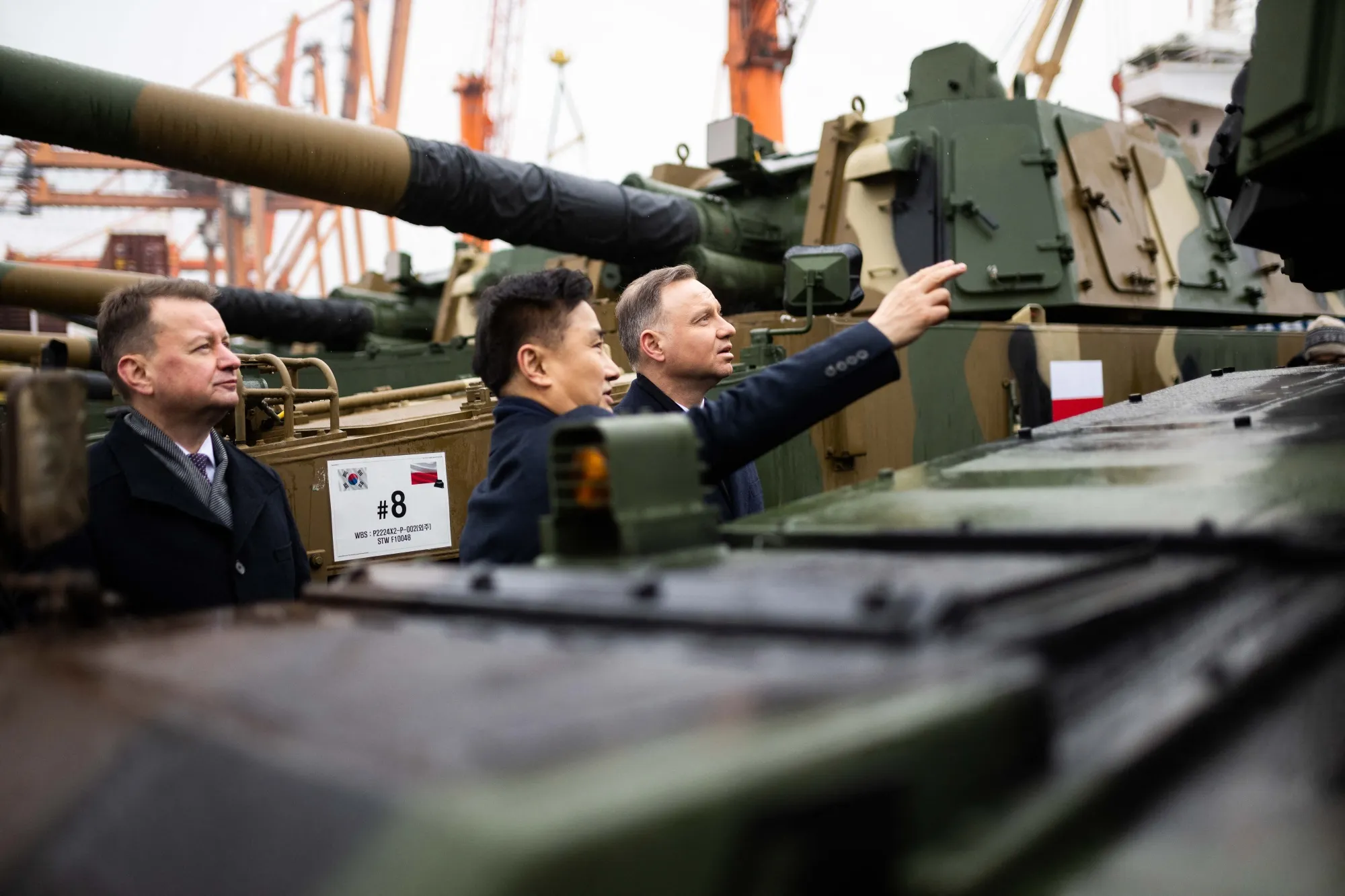 Andrzej Duda, right, reviews South Korean K2 battle tanks and South Korean K9 howitzers delivered to Poland, on Dec. 6.