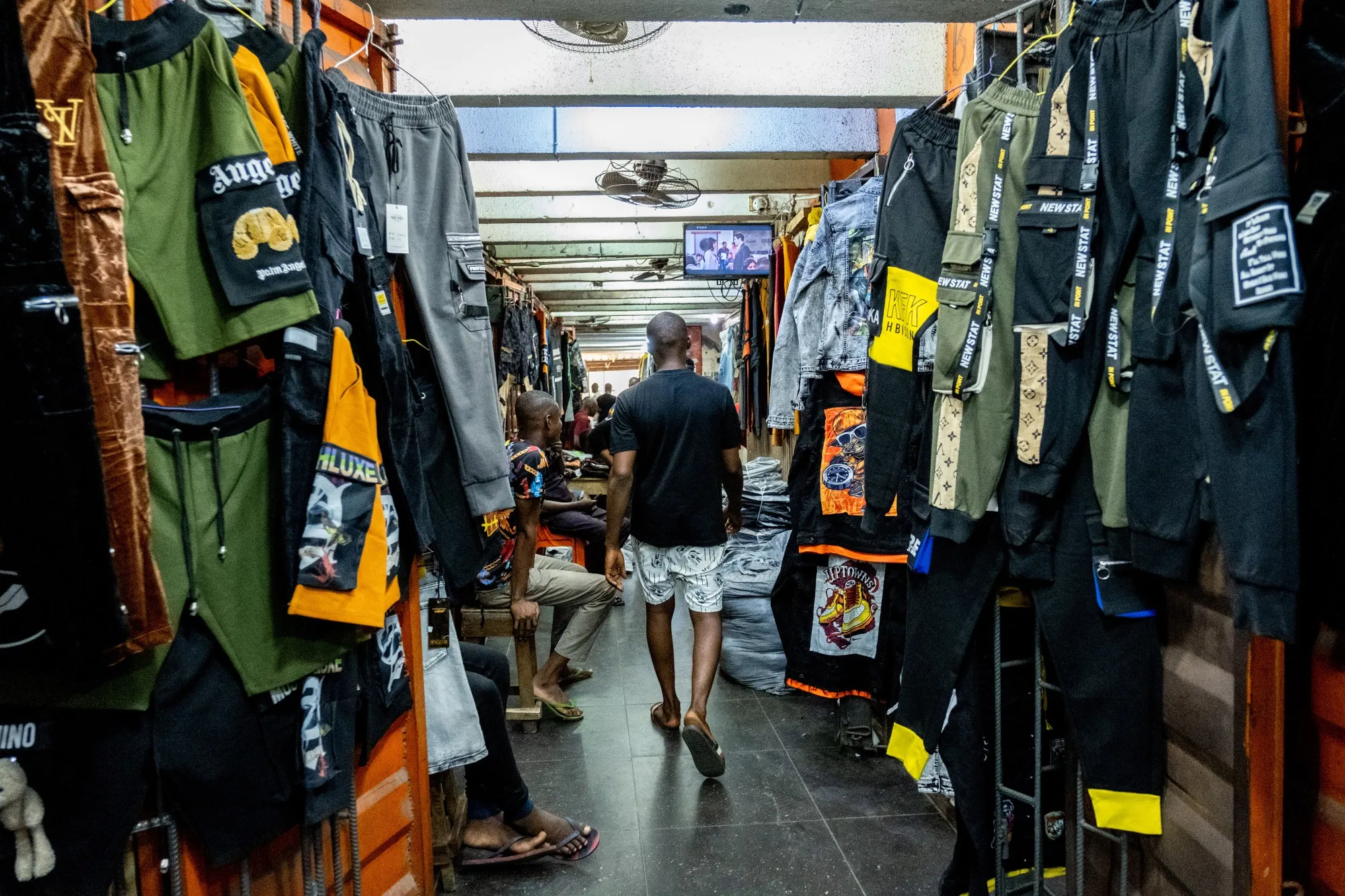 A shopper walks past stalls inside a market in Lagos, Nigeria.&nbsp;