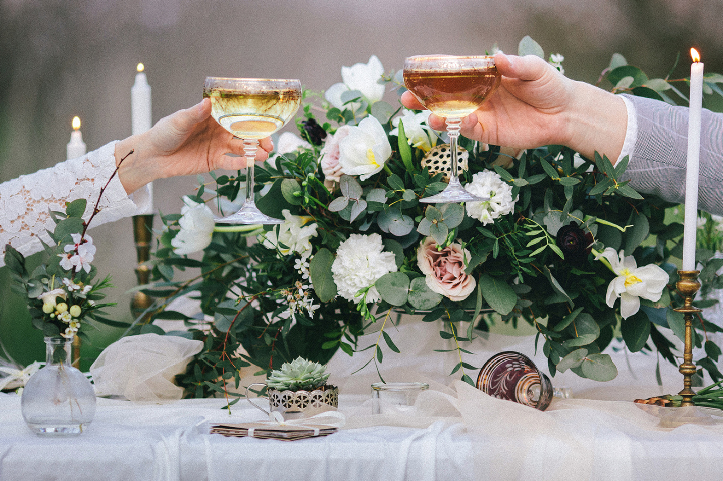 Raising glasses with champagne at the wedding table