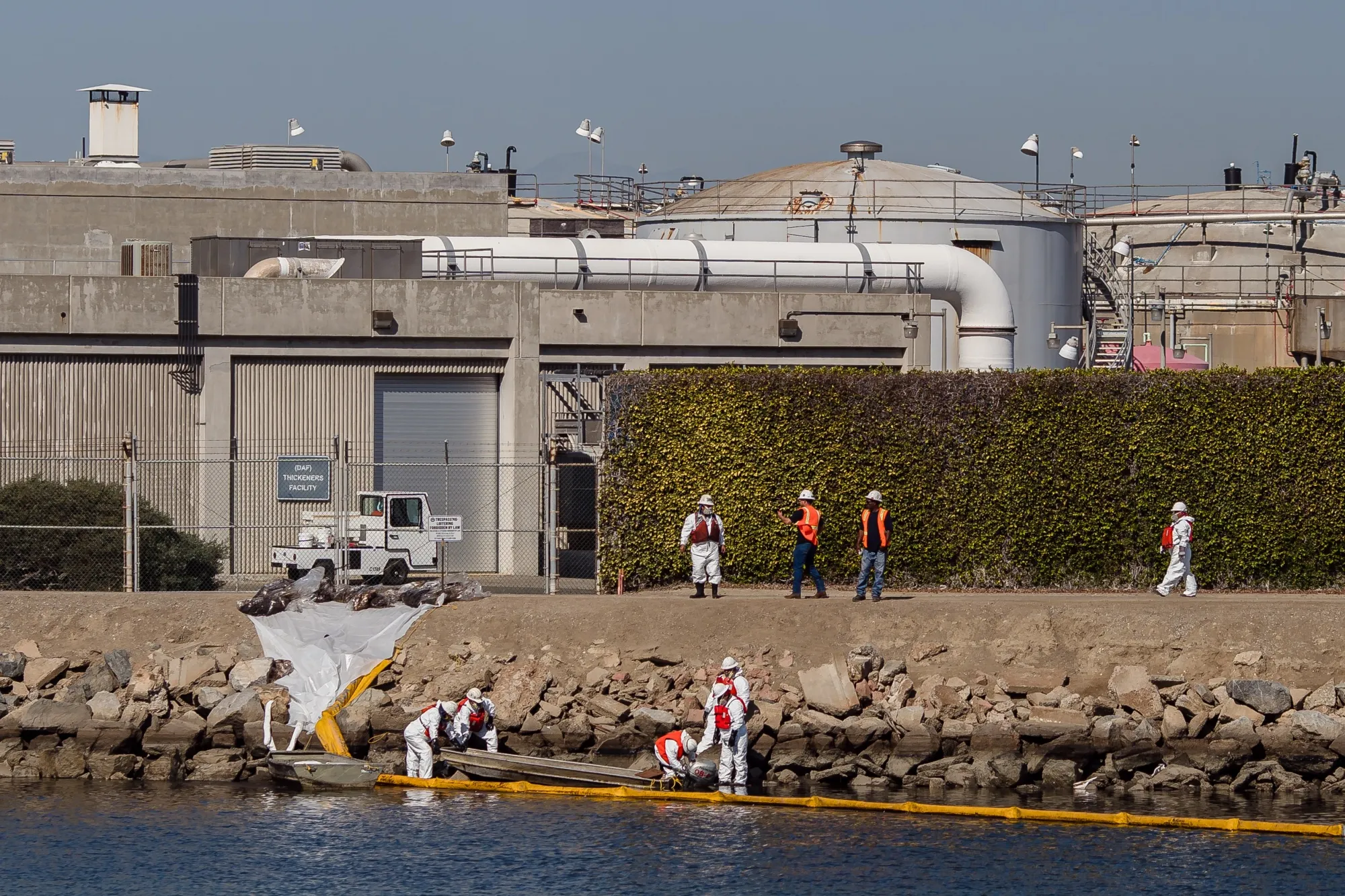 Workers clean up during an oil spill at the Talbert Marsh in Huntington Beach, California, on&nbsp;Oct. 3, 2021.