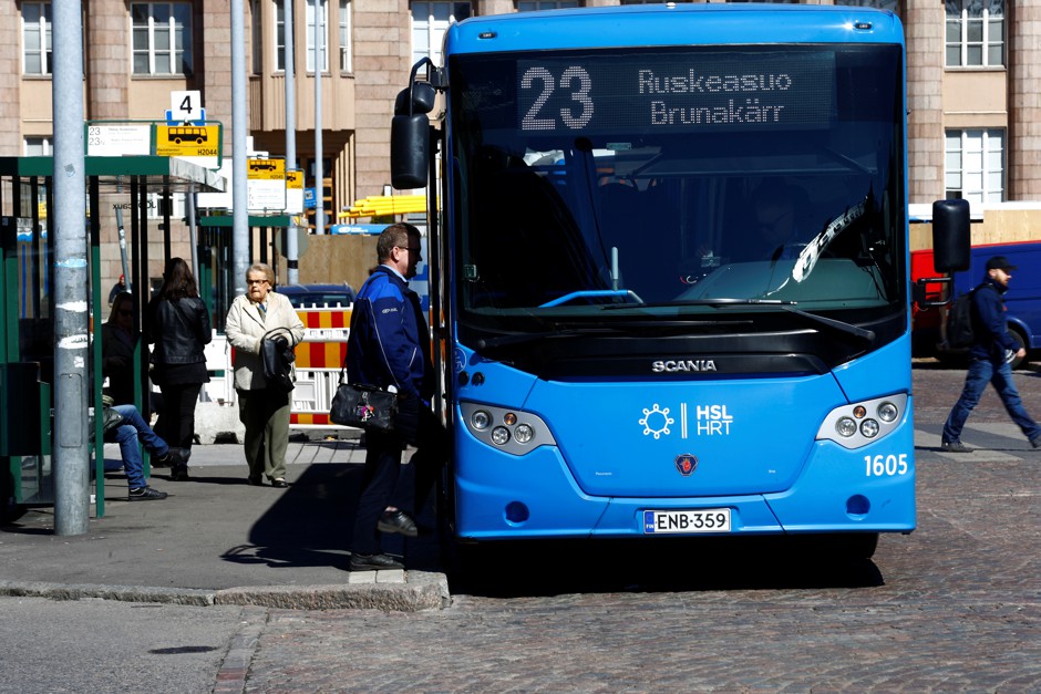 A man enters a public bus in Helsinki where, since 2016, Whim has been offering the ability to use one app to purchase rides with public transport, shared cars and bikes, and taxis.