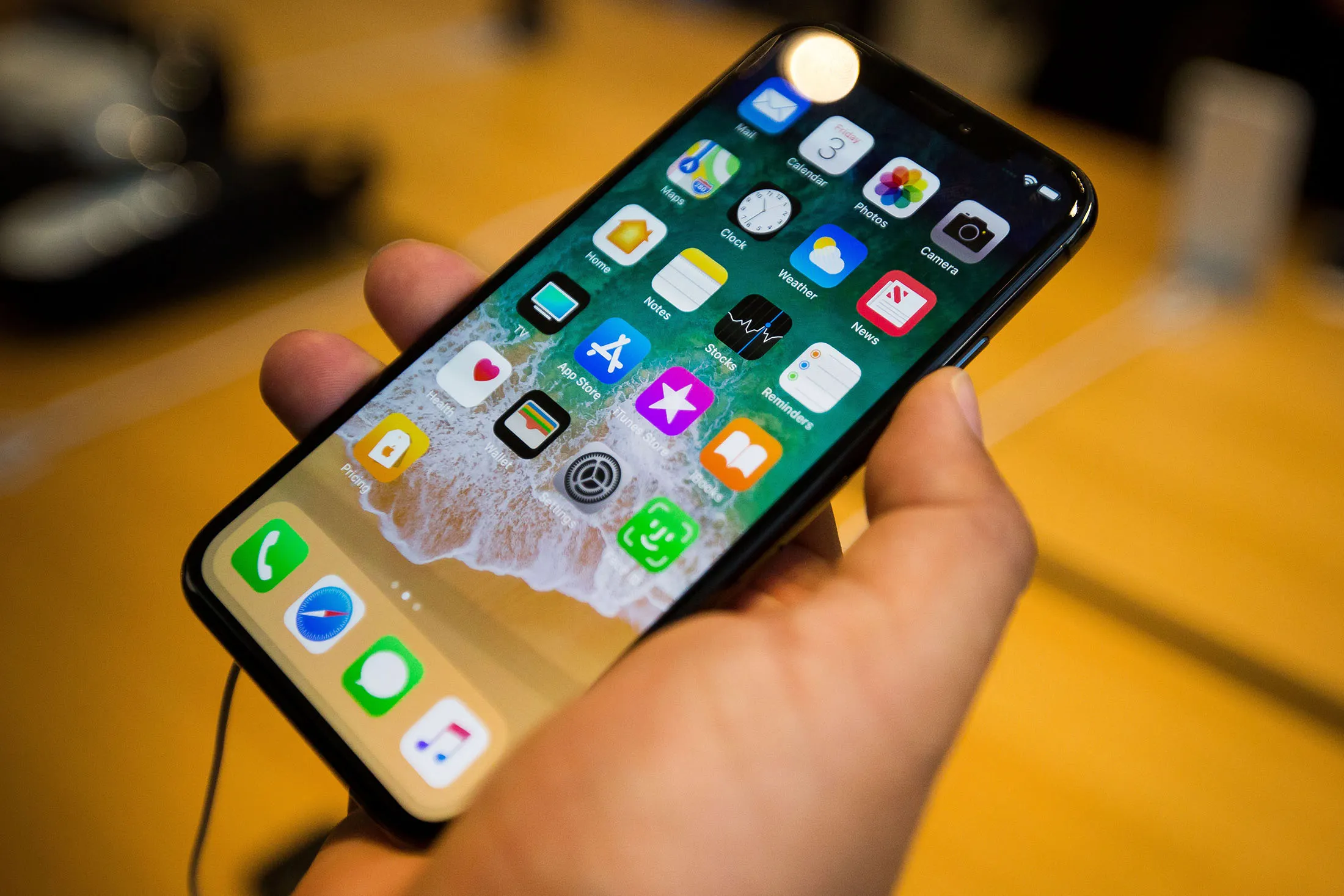 A customer holds an Apple Inc. iPhone X smartphone during the sales launch at a store in New York, U.S.