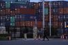 Shipping containers sit stacked at a terminal at dusk in Tokyo, Japan, on Monday, April 15, 2019. Japans chief negotiator dodged questions about any potential auto export penalties or currency clause as he emerged from the first day of long-awaited trade talks with the U.S. in Washington, D.C., U.S., on April 15.