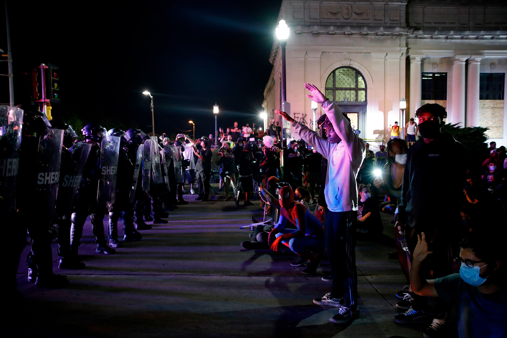 Protestors face police outside the County Courthouse during demonstrations in Kenosha, Wisconsin on Aug. 25.
