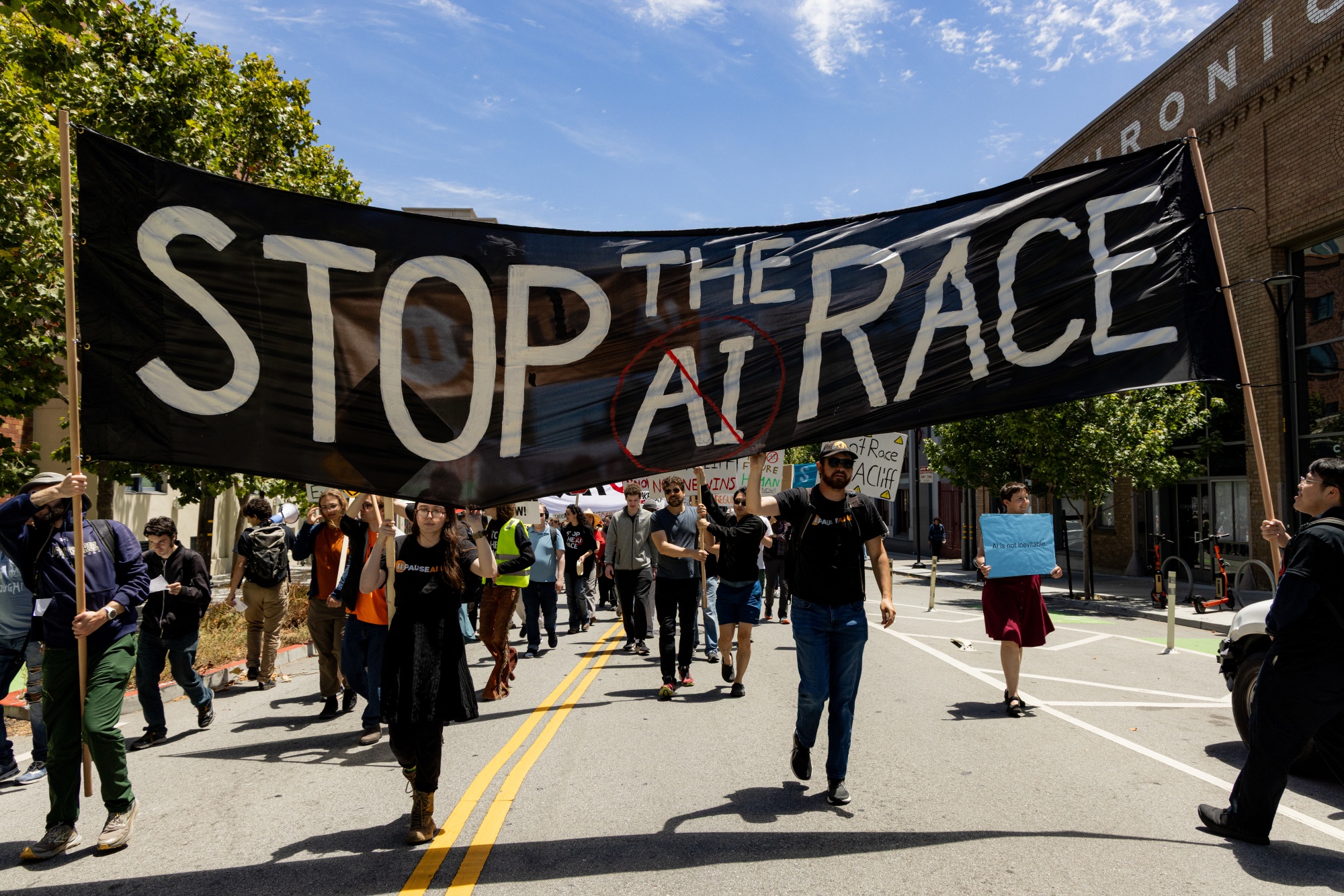 Demonstrators march during a protest against AI