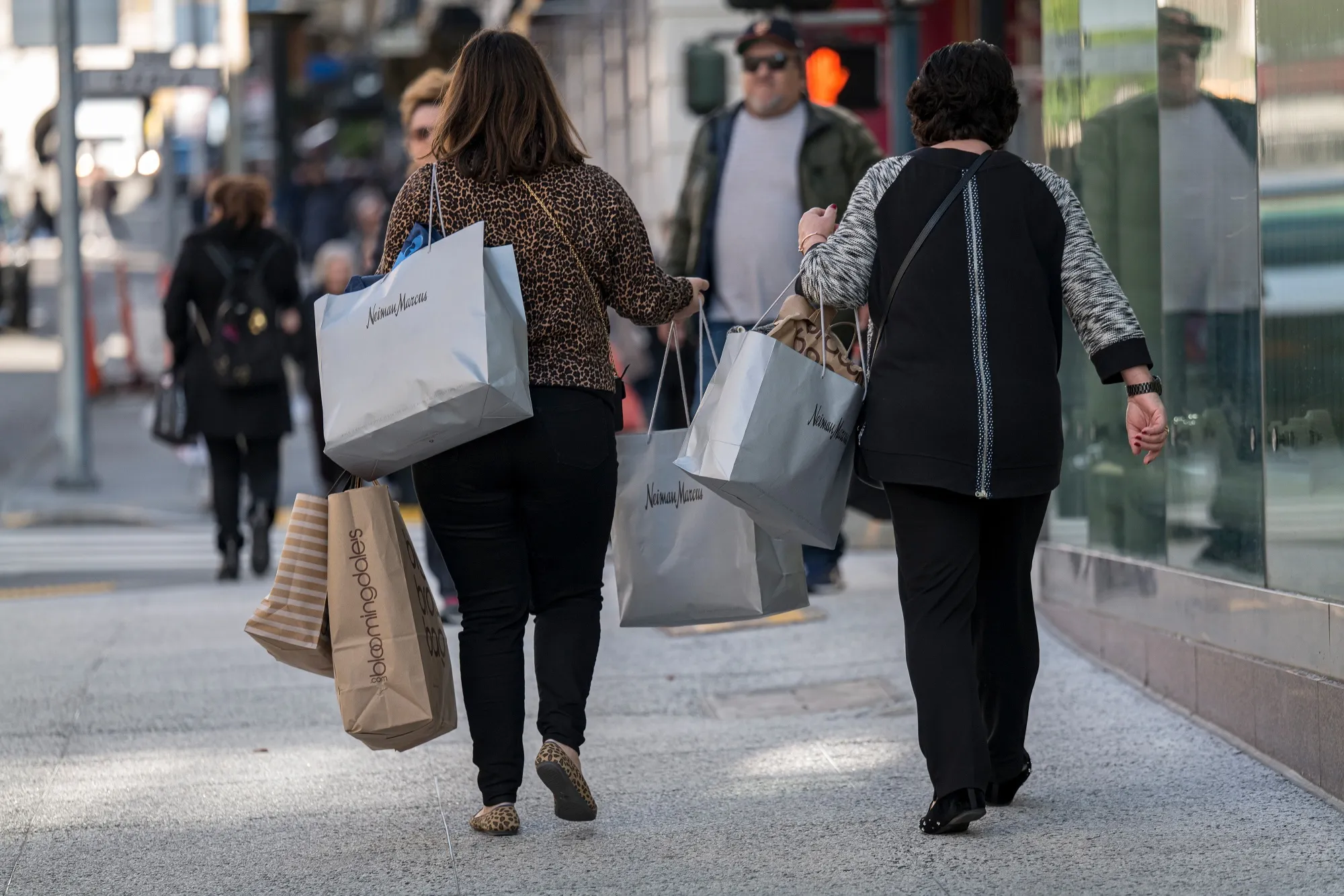 Pedestrians carry shopping bags in San Francisco.