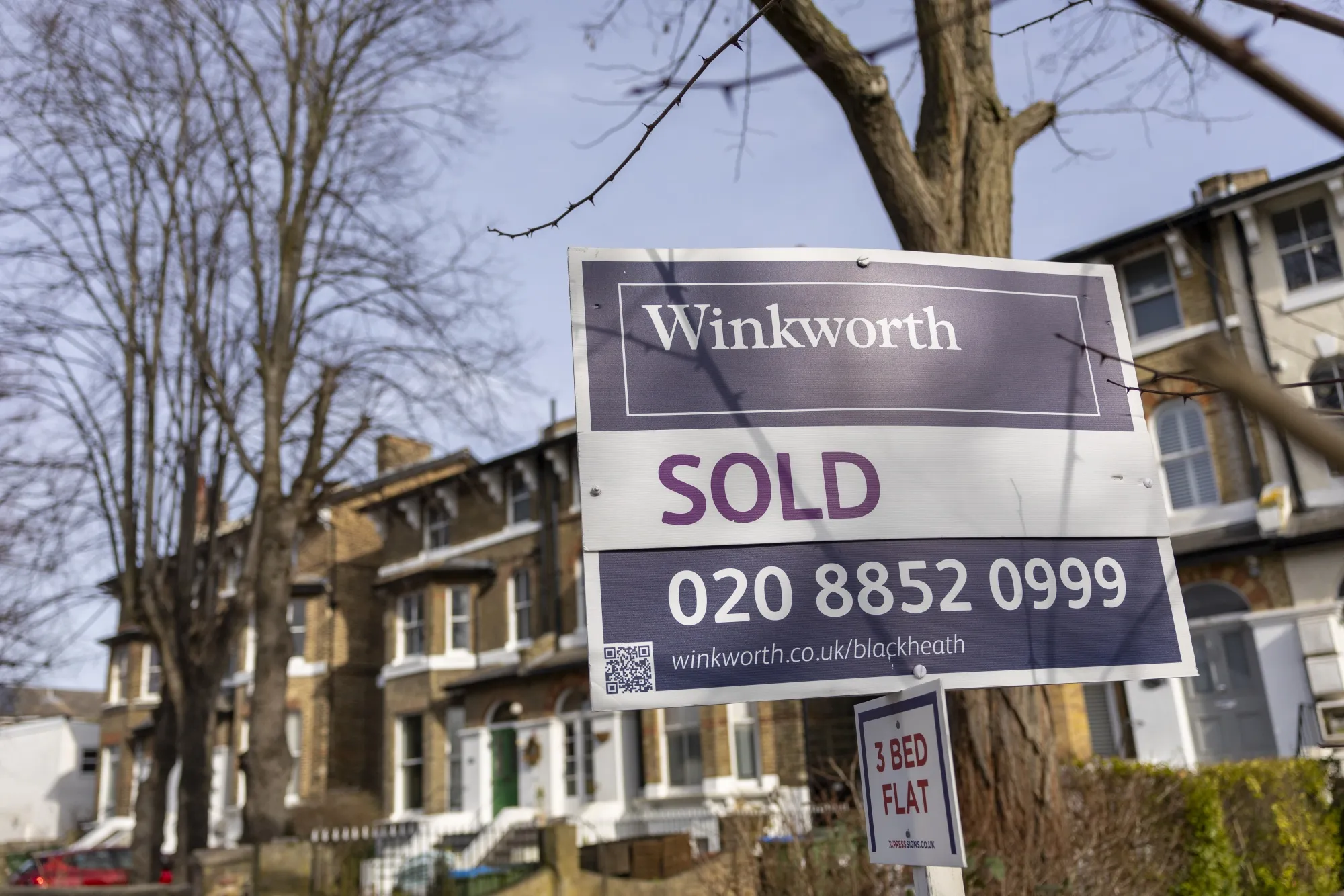 An Estate agents 'Sold' sign outside residential homes in London.