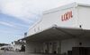 The Lixil Group Corp. logo is displayed at the company's Enokido plant in Tokoname, Aichi Prefecture, Japan, on Friday, Sept. 9, 2016. In August, Lixil announced a 39 percent increase in first-quarter operating income, citing favorable currency moves and the absence of one-off losses. The company’s shares surged the most since 2008.
