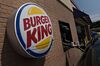 An employee assists a customer at the drive-through of a Burger King Worldwide Inc. restaurant in Peoria, Illinois.