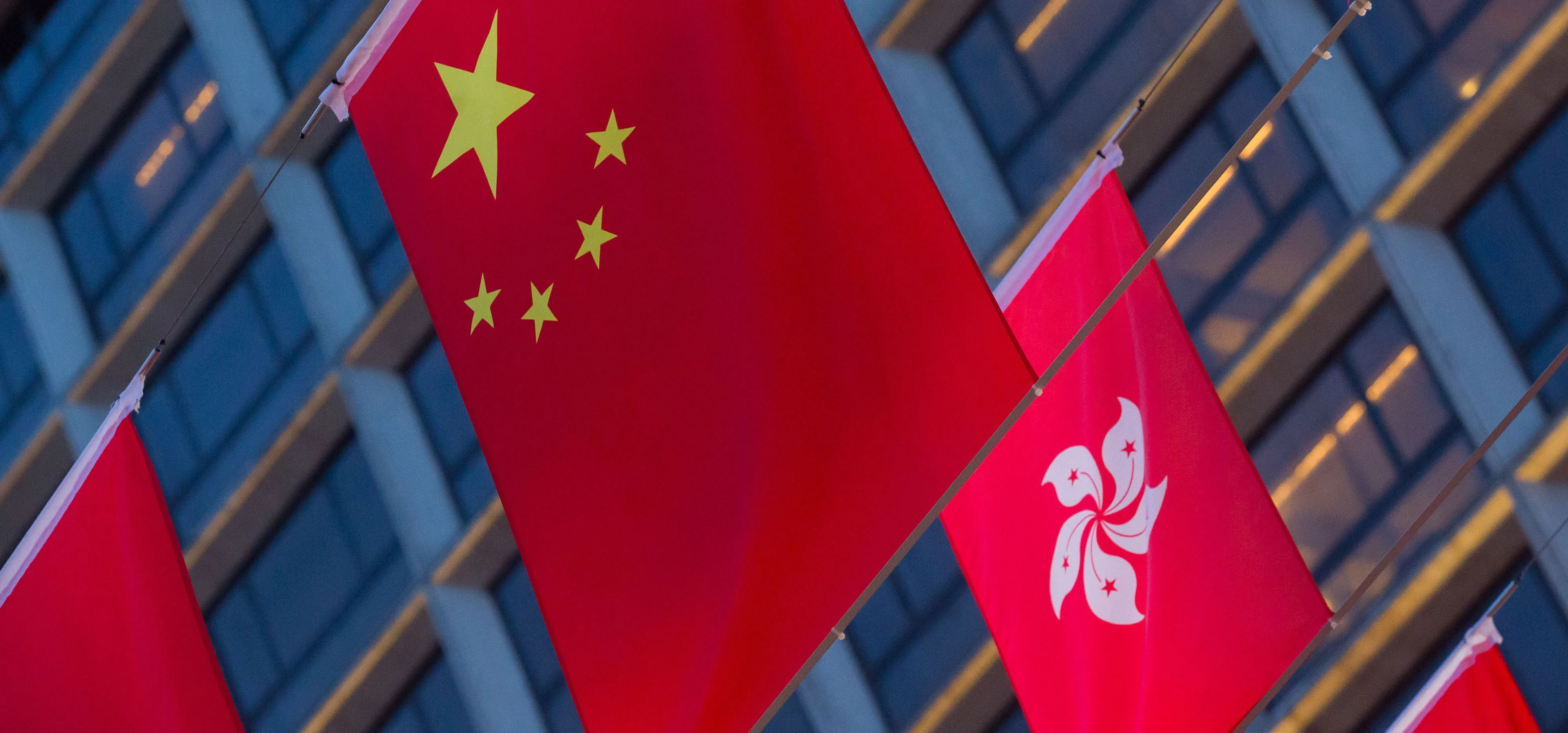 The flags of China and the Hong Kong Special Administrative Region hang in a display ahead of Chinese President Xi Jinping's arrival in Hong Kong, China, on Wednesday, June 28, 2017. Hong Kong is making preparations to mark the 20th anniversary of the former British colony's return to Chinese rule, with July 1 marking the first time Xi will visit the city since taking office.
