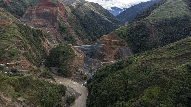 An overview showing gold miinig operations surrounded by mountains in the town of Chima.