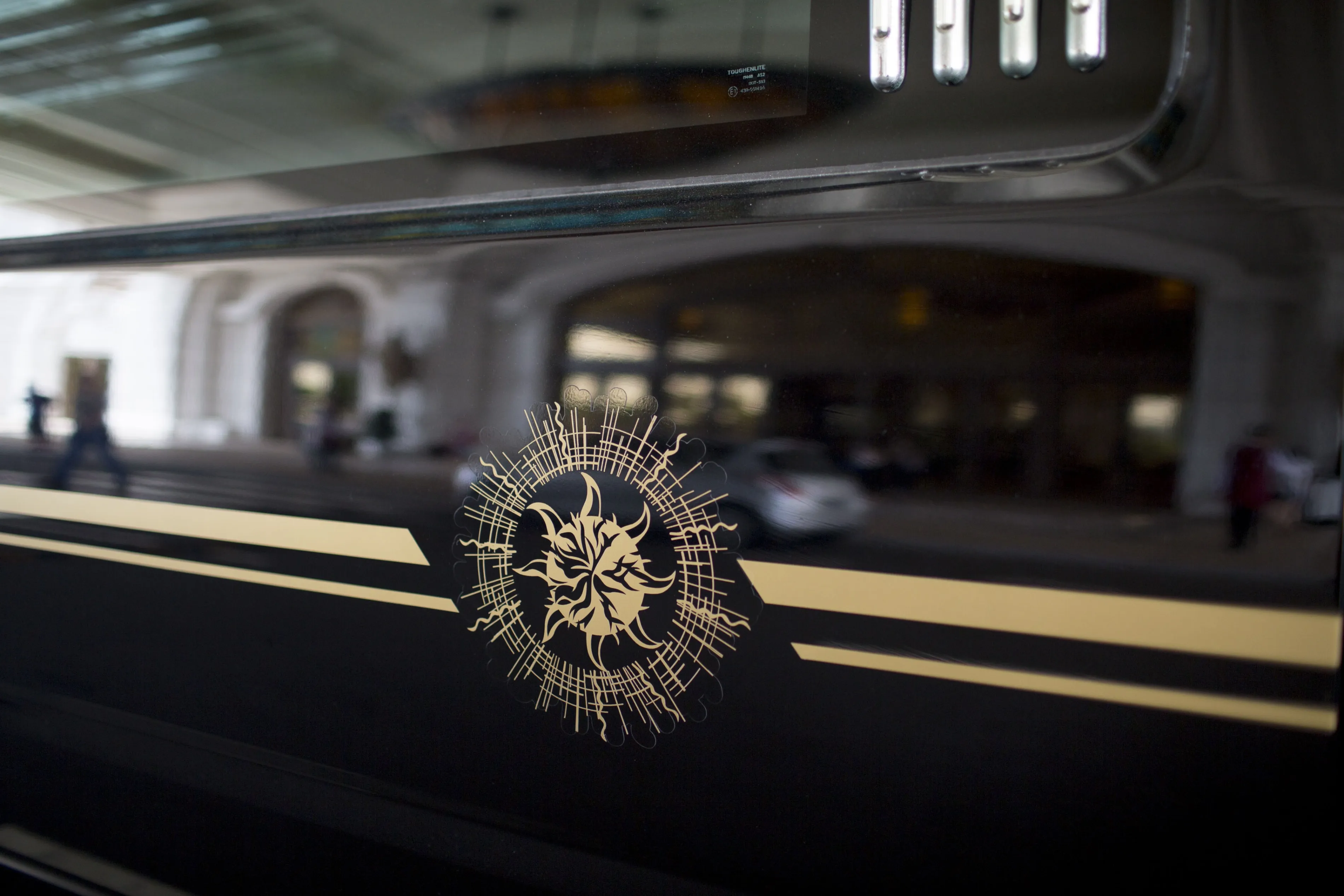 The SunCity Group logo is displayed on a limousine outside a casino in Macau, China.