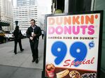 A man walks out from a Dunkin' Donuts franchise in New York City. 