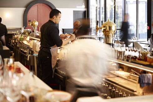 Large, red doors on either side of the bar lead to the main dining rooms.