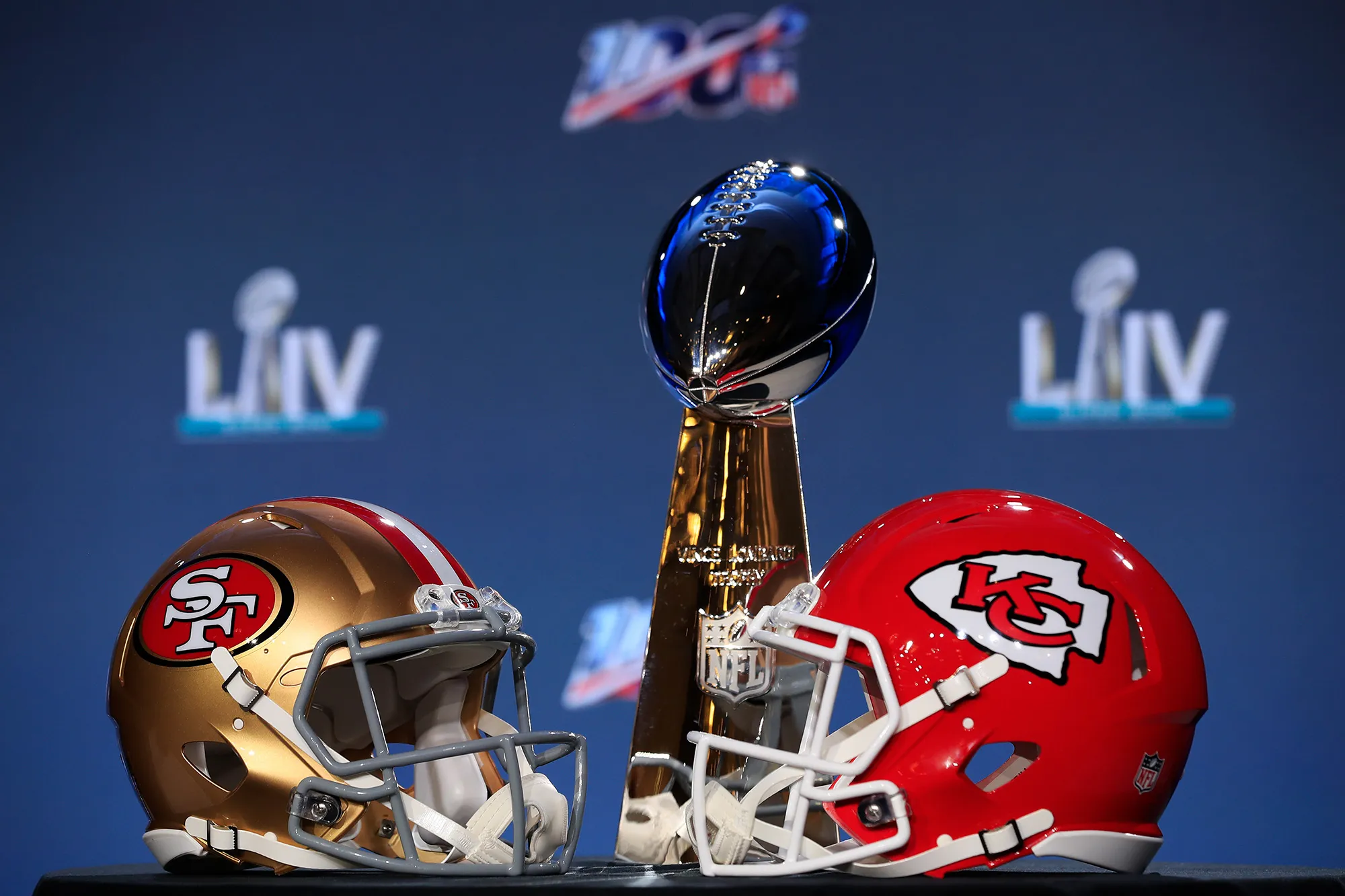 The Vince Lombardi Trophy with helmets of the San Francisco 49ers and Kansas City Chiefs.