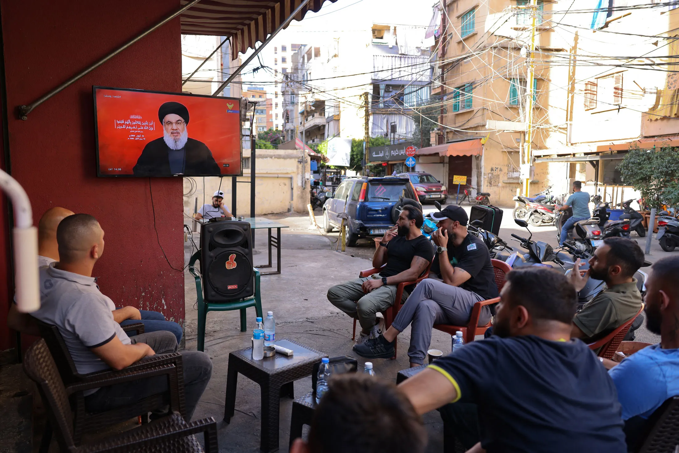 People watch Hassan Nasrallah during his televised address, in Beirut on Sept. 19.