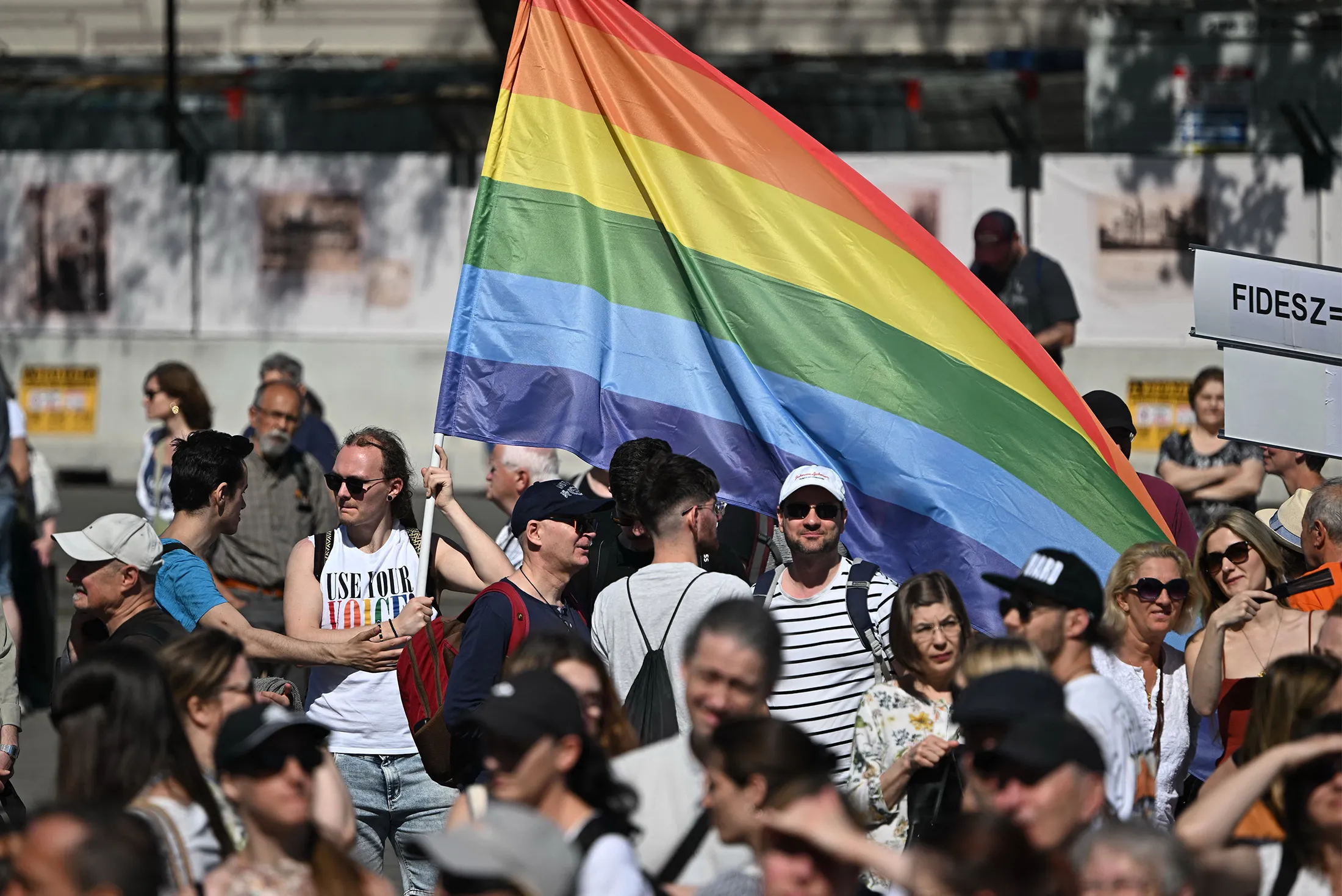 A demonstrator holds a rainbow flag as participants protest against the policy of Hungary's Prime Minister Viktor Orban in front of the parliament building in Budapest, Hungary, on May 1.