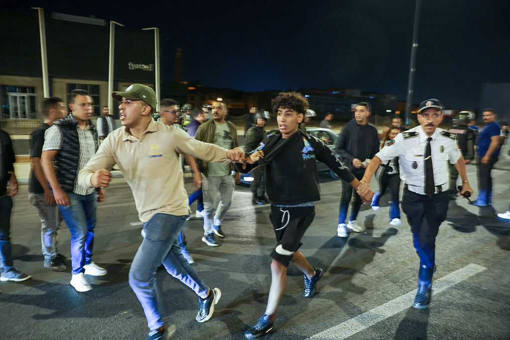 TOPSHOT - Members of the security forces detain a protester during a youth-led demonstration demanding reforms in the healthcare and education sectors in Sale on October 1, 2025. Two people were killed when officers opened fire on a group of people attempting to &quot;storm&quot; a police station in Morocco on October 1, state media said, as protests -- sometimes violent -- roil the north African nation. Demonstrations have convulsed Morocco for several days, urged on by the GenZ 212 group, a recently formed collective based on the Discord web platform whose organisers remain unknown. (Photo by Abdel Majid BZIOUAT &#x2F; AFP) (Photo by ABDEL MAJID BZIOUAT&#x2F;AFP via Getty Images) Photographer: ABDEL MAJID BZIOUAT&#x2F;AFP