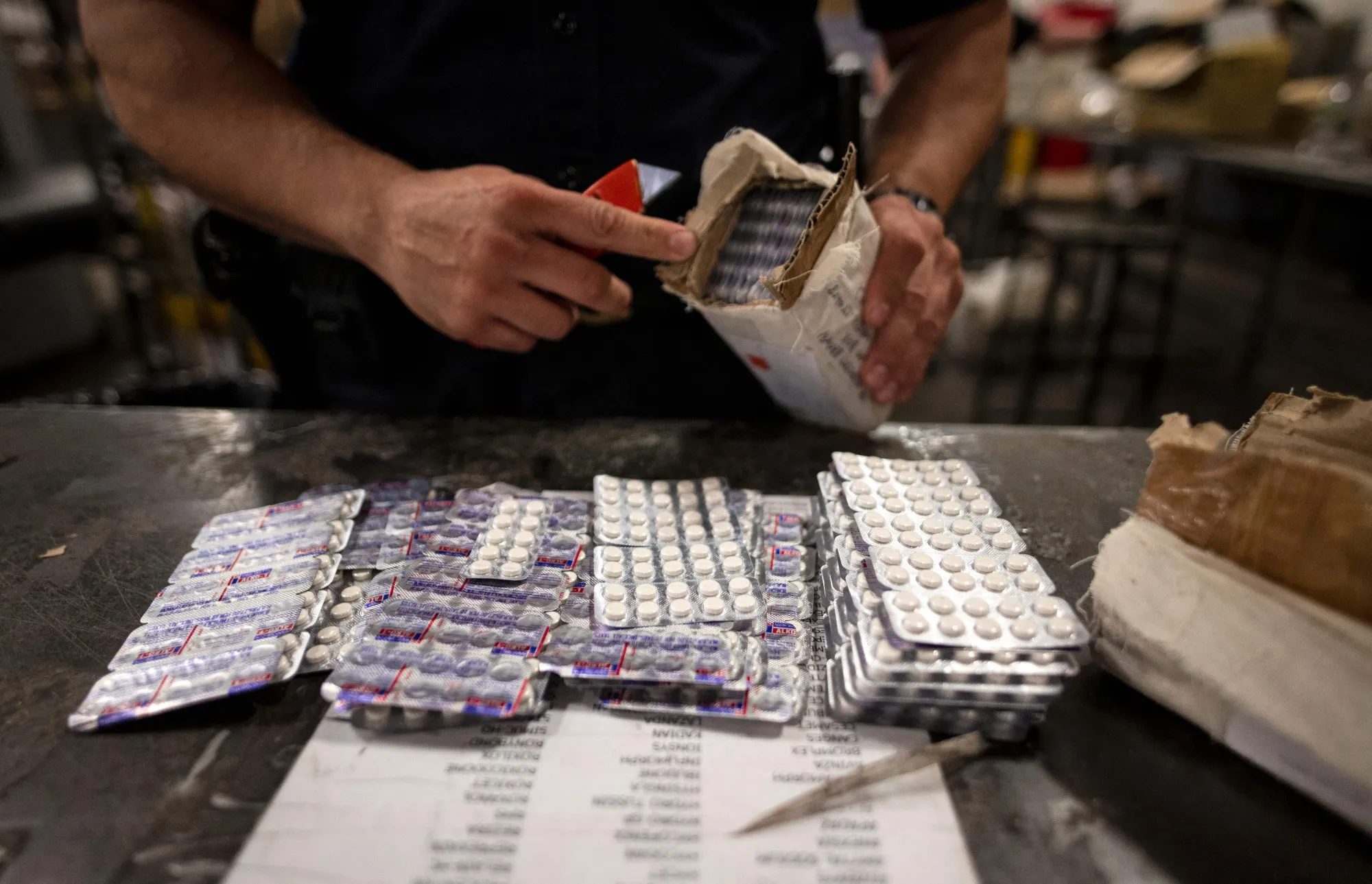 A US Customs and Border Protection officer&nbsp;finds synthetic opioid pills in a parcel at John F. Kennedy Airport's US Postal Service facility&nbsp;in New York.