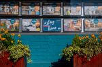 A stay at home sign sits in the window of a real estate agents in London.