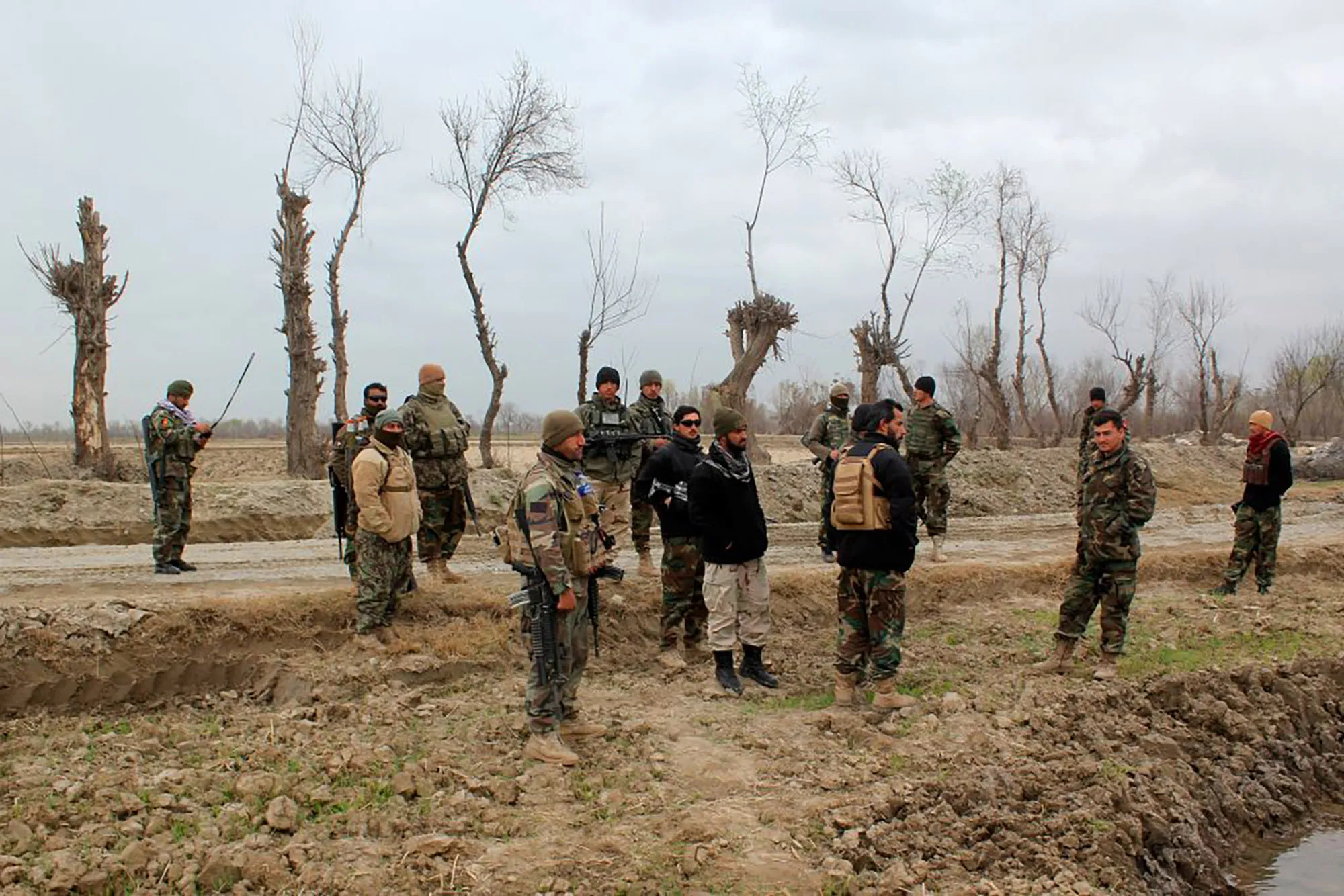Afghan security forces stand guard after an attack by Taliban militants near an Afghan National Army (ANA) outpost, in Kunduz