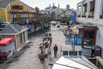 Pedestrians walk on Pier 39 in San Francisco on March 16.