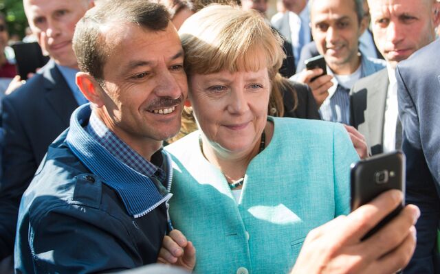 September 10, 2015, an asylum seeker taking a selfie picture with German Chancellor Angela Merkel following Merkel's visit at a branch of the Federal Office for Migration and Refugees and a first registration centre for asylum-seekers in Berlin.