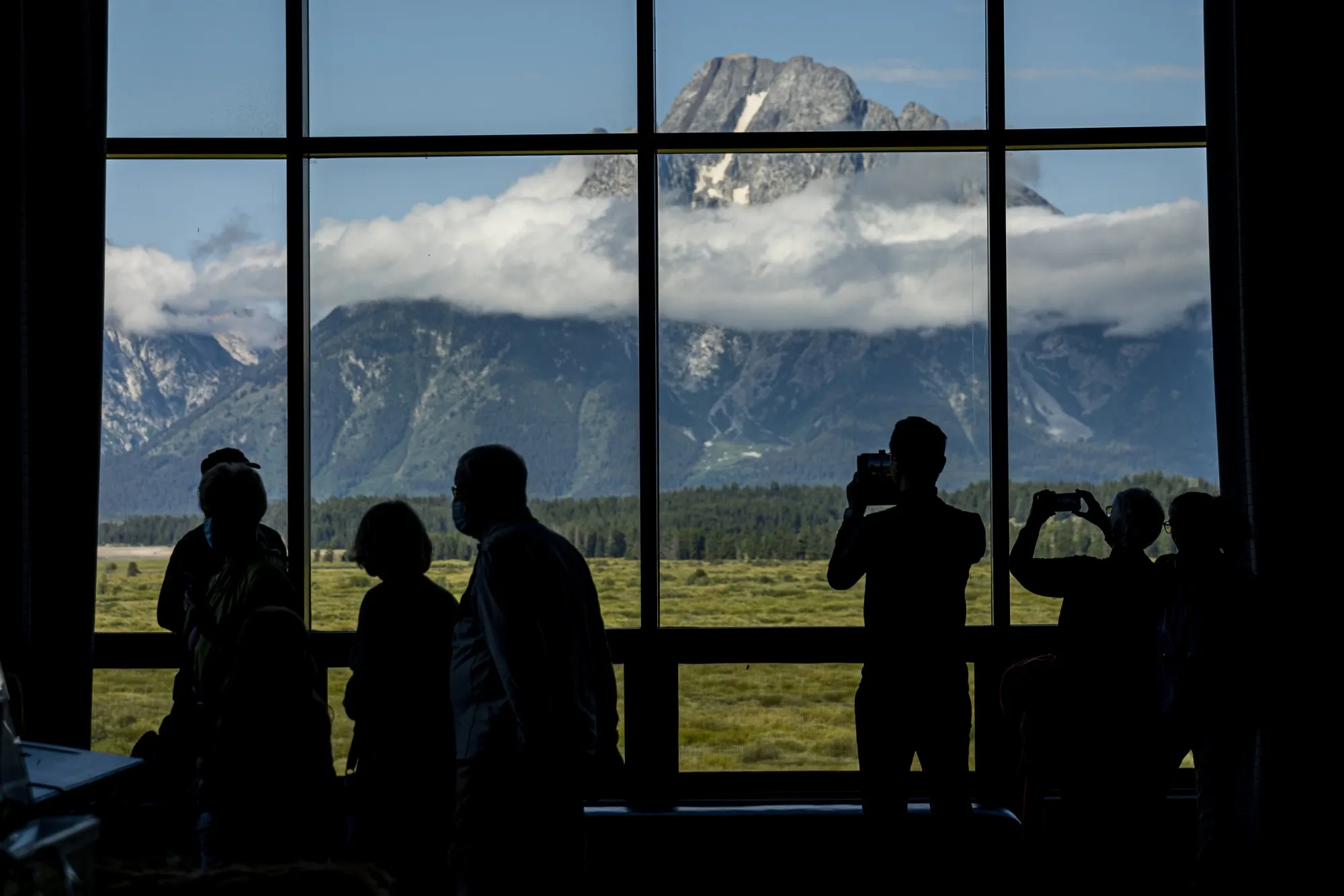 Visitors take photos of the Grand Teton National Park mountain range from Jackson Lake Lodge&nbsp;in Moran, Wyoming.
