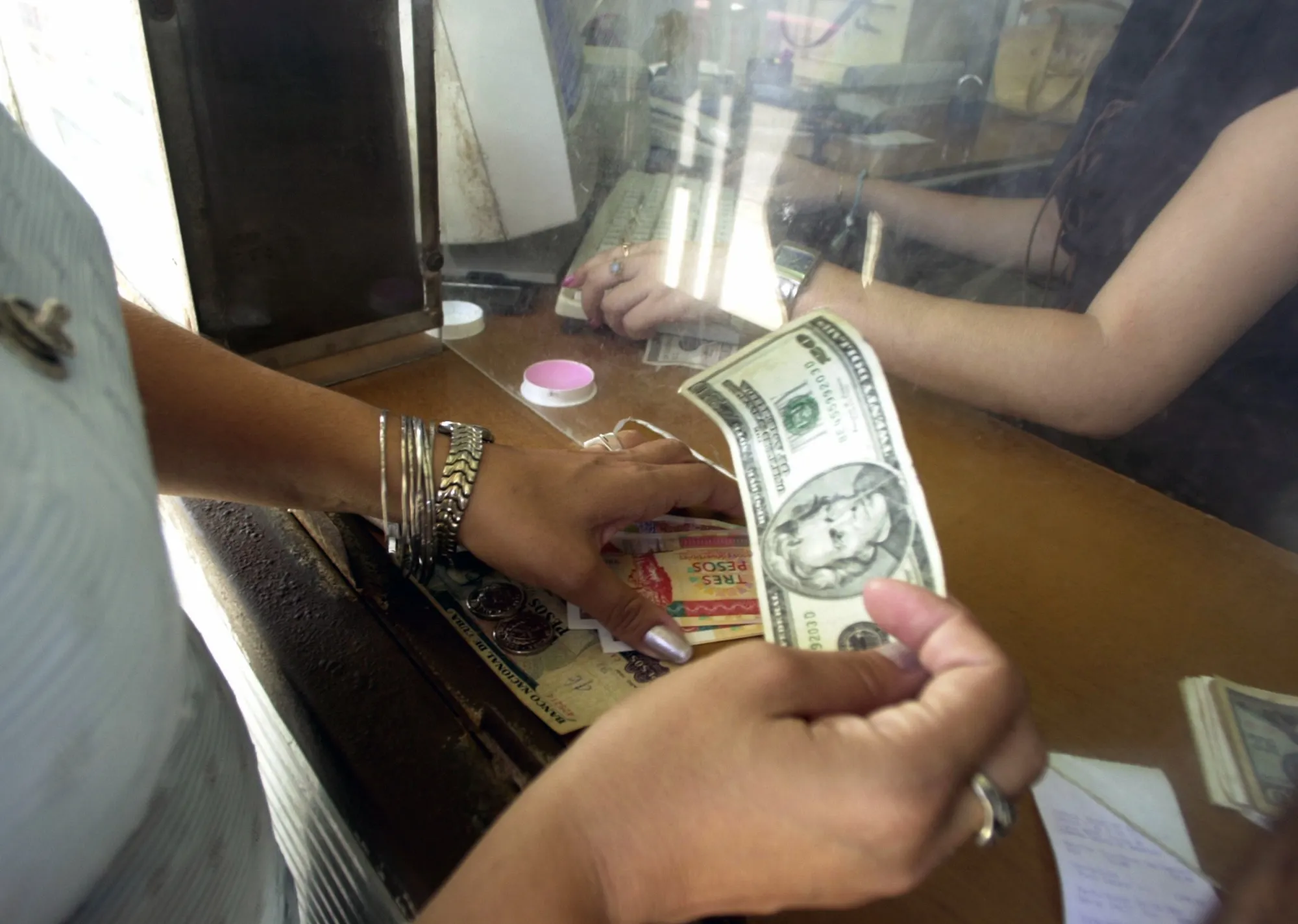A woman makes a currency exchange in Havana.