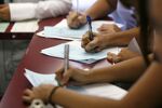 Applicants fill out forms at a job fair in Los Angeles.