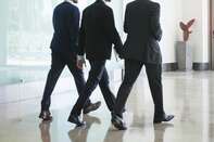 Business associates chatting while walking together