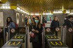 A commuter, wearing a protective face mask, exits the ticket barriers the Duomo station of the Milan Metro on Feb. 24.