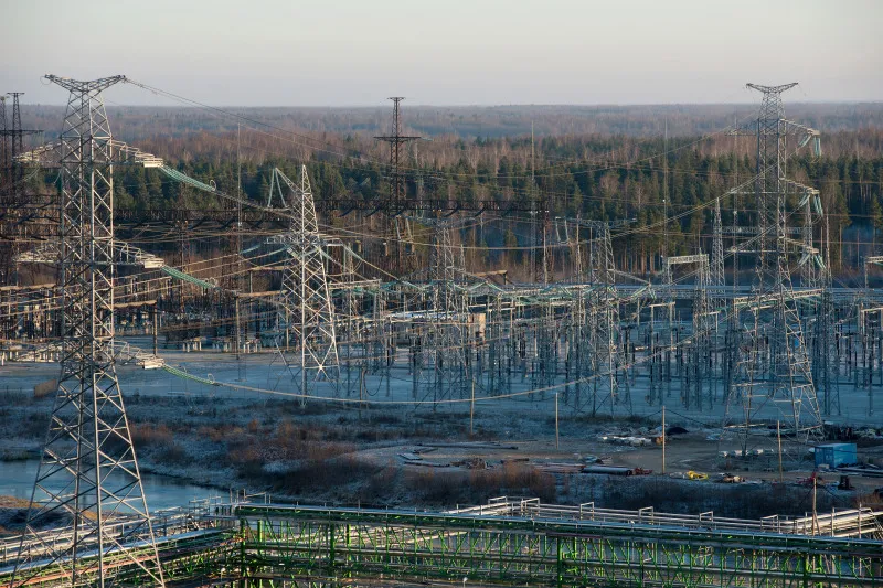 High voltage electricity power lines hang from pylons at Eesti Energia AS's Enefit 280 oil shale processing plant and energy production facility in Narva, Estonia