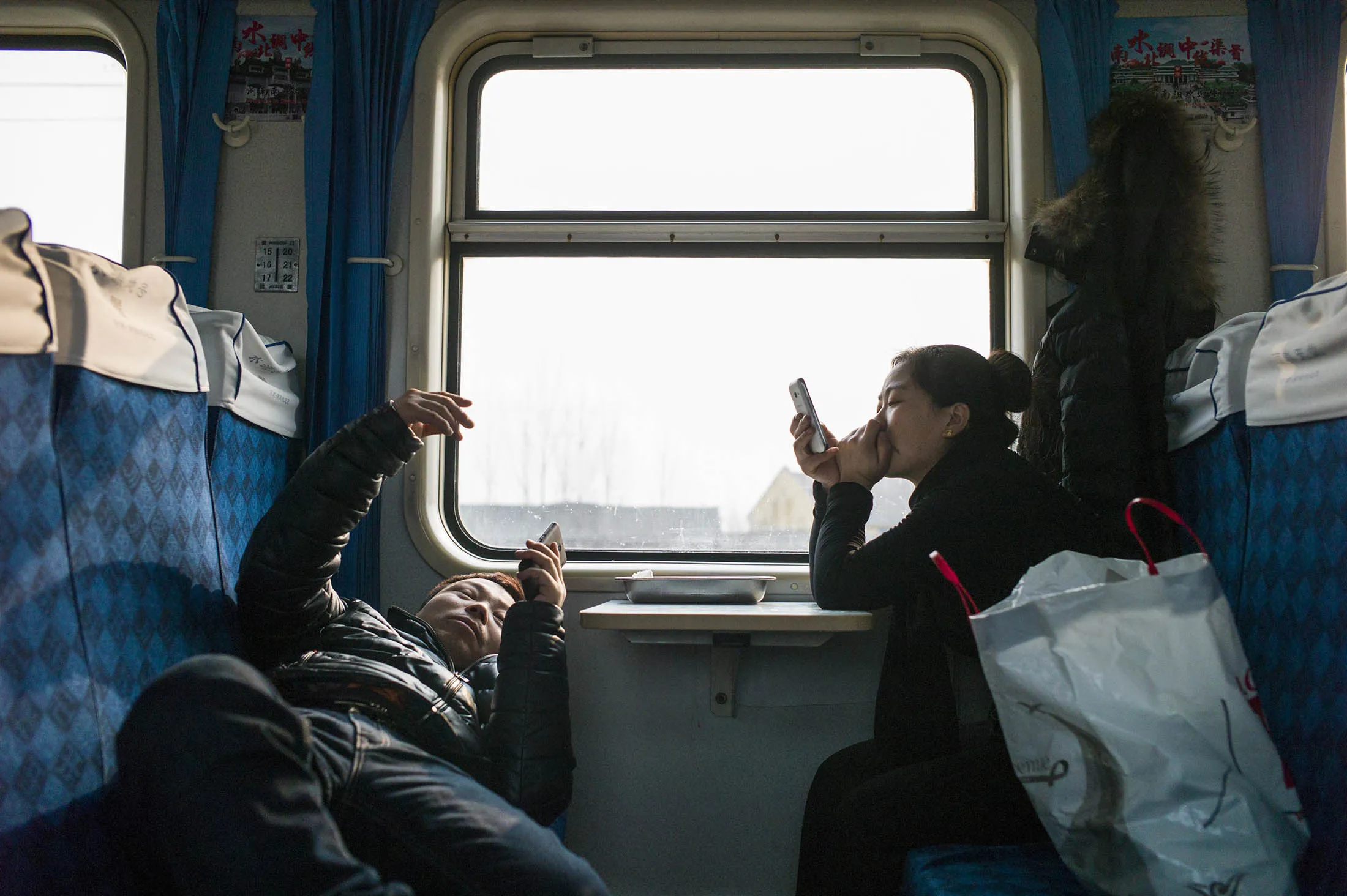 Chinese travellers wait for the train to set off as they head to their hometown for the Lunar New Year. a total of 42 million individual voyages by air and 258 million one-way train journeys are taken over the period that started Jan. 24 this year.
