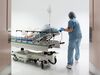 Nurse wheeling patient to surgery OR