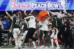 The Michigan State team celebrates a victory over Pittsburgh after the Peach Bowl NCAA college football game, Thursday, Dec. 30, 2021, in Atlanta. Michigan State won 31-21.(AP Photo/John Bazemore)