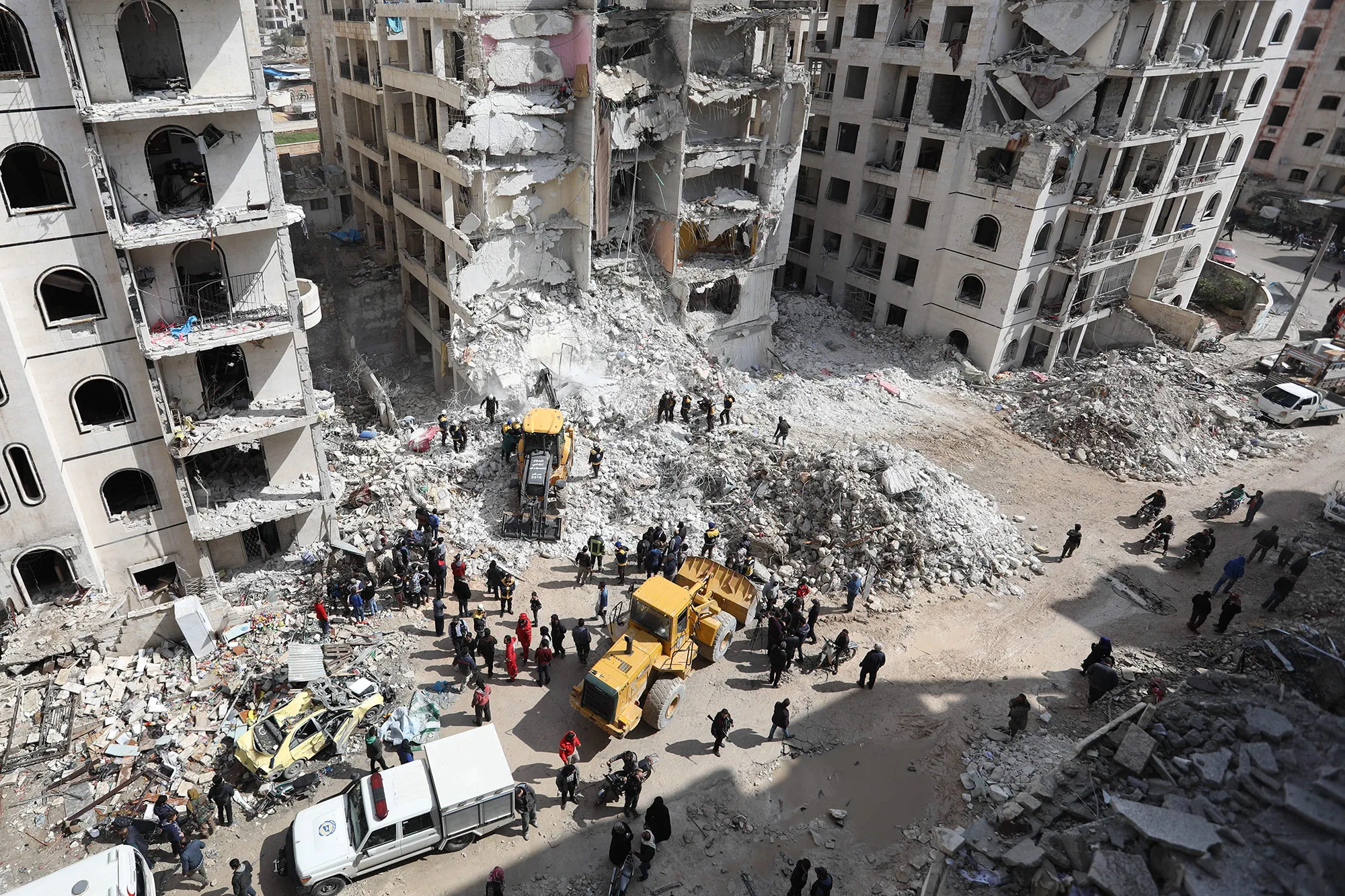 Syrian rescue teams clear the rubble in the morning of April 10, 2018 at the site of an explosion of unknown origin which wrecked a multi-storey building the previous night in the war-battered country's northwestern city of Idlib.