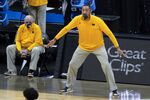 Michigan head coach Juwan Howard reacts to a play as associate head coach Phil Martelli watches from the bench during the first half of the team's Elite Eight game against UCLA in the NCAA men's college basketball tournament March 30, 2021, in Indianapolis. Martelli will fill in for Howard for the rest of the regular season. Howard was suspended five games and fined $40,000 by the Big Ten Conference after hitting a Wisconsin assistant coach in the head during the handshake line after a loss Sunday, Feb. 20. (AP Photo/Darron Cummings, File)