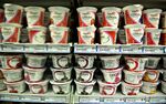 Yoplait USA Inc. brand greek yogurt sits on a shelf above Chobani Inc. greek yogurt at a supermarket in Princeton, Illinois, U.S., on Tuesday, June 4, 2013. The Food and Agriculture Organization of the United Nations will release its monthly food price index on June 6. The index, a measure of the monthly change in international prices of a basket of food commodities, consists of the average of five commodity group price indices including meat, dairy, grains, oil and sugar.
