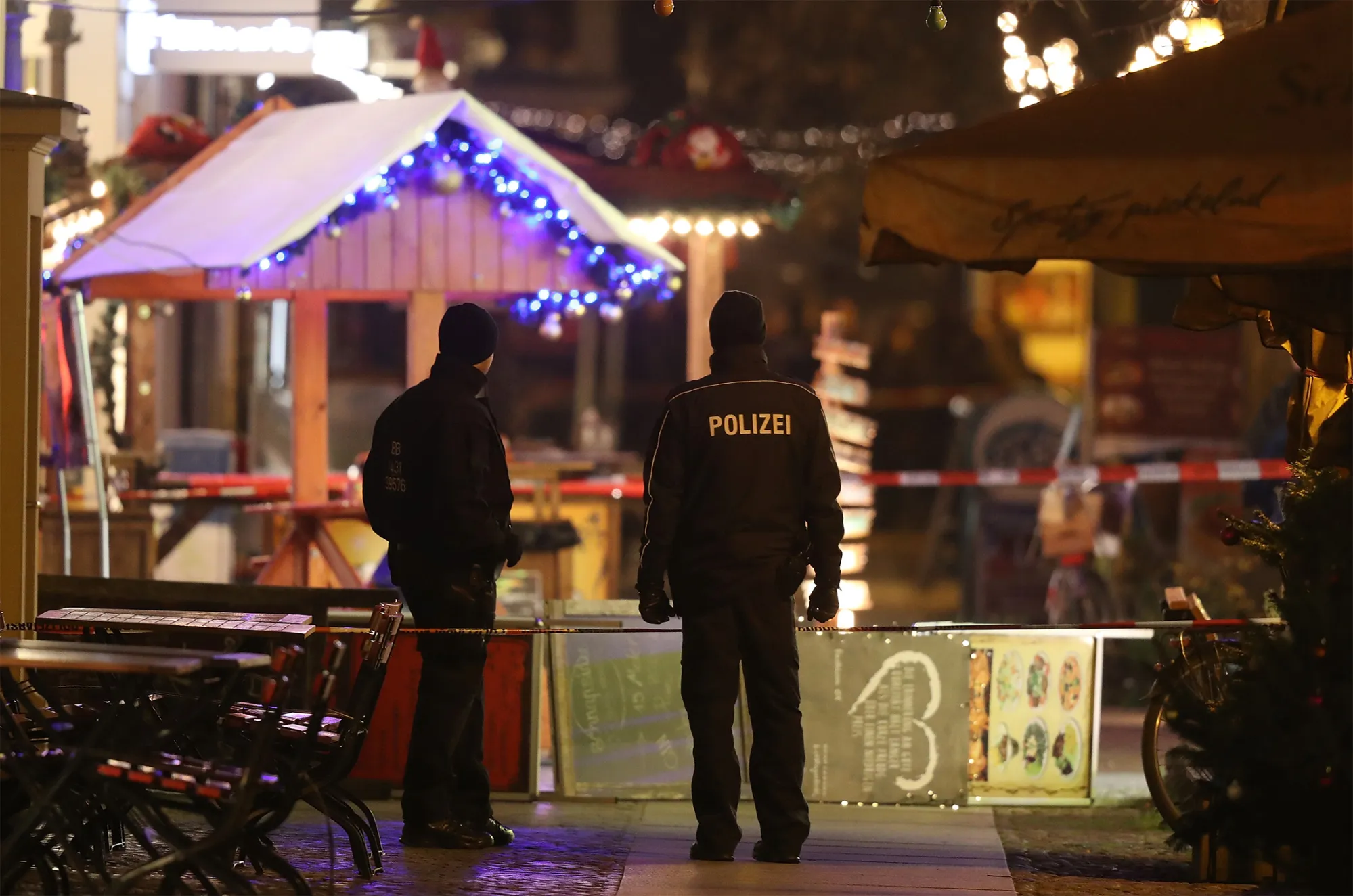 Police stand in a roped-off area at a Christmas market close to where an explosive device was found earlier in the day on Dec. 1, 2017 in Potsdam, Germany.