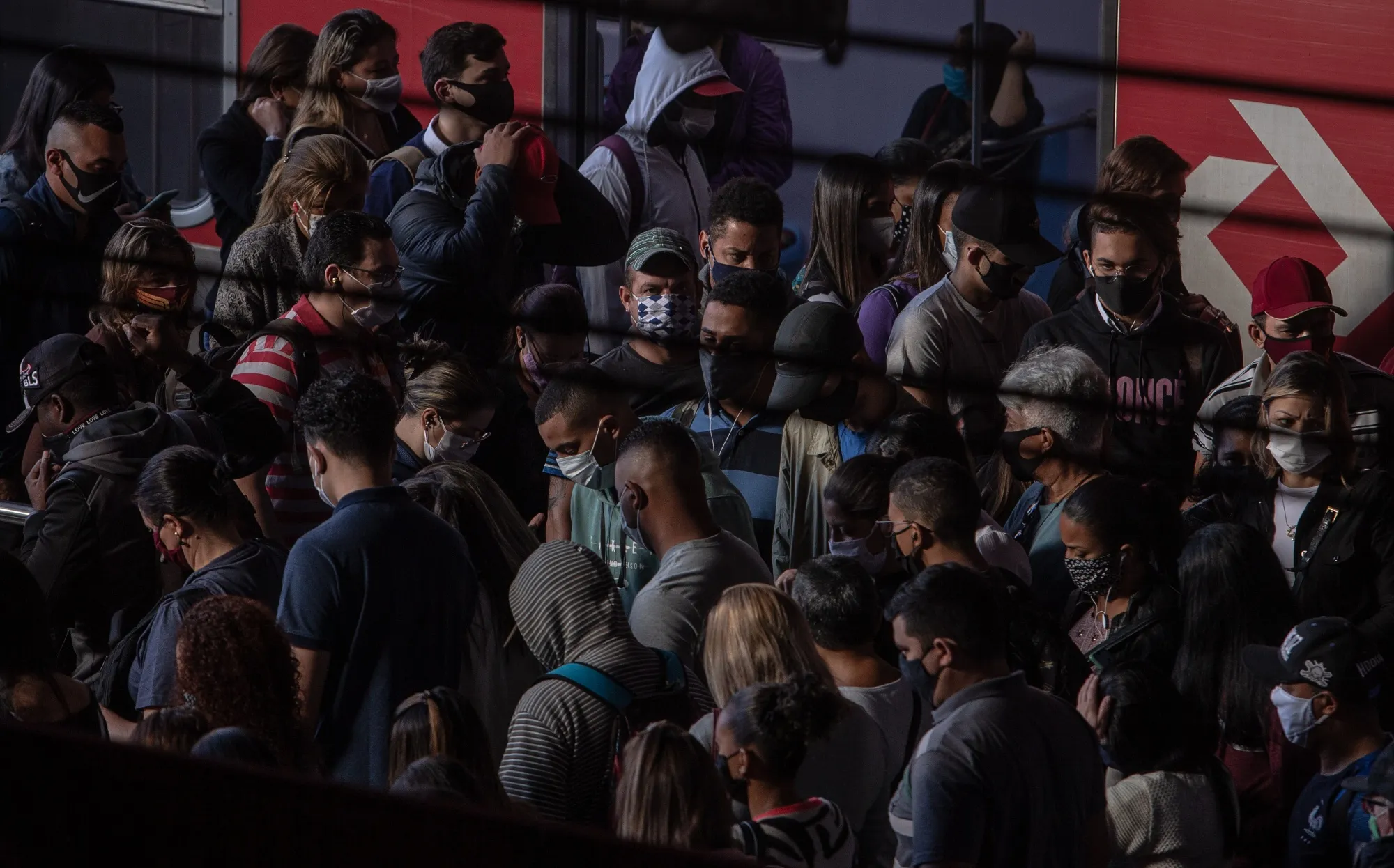 Commuters wearing protective masks walk inside the Luz train station in Sao Paulo, Brazil, on&nbsp;June 22.